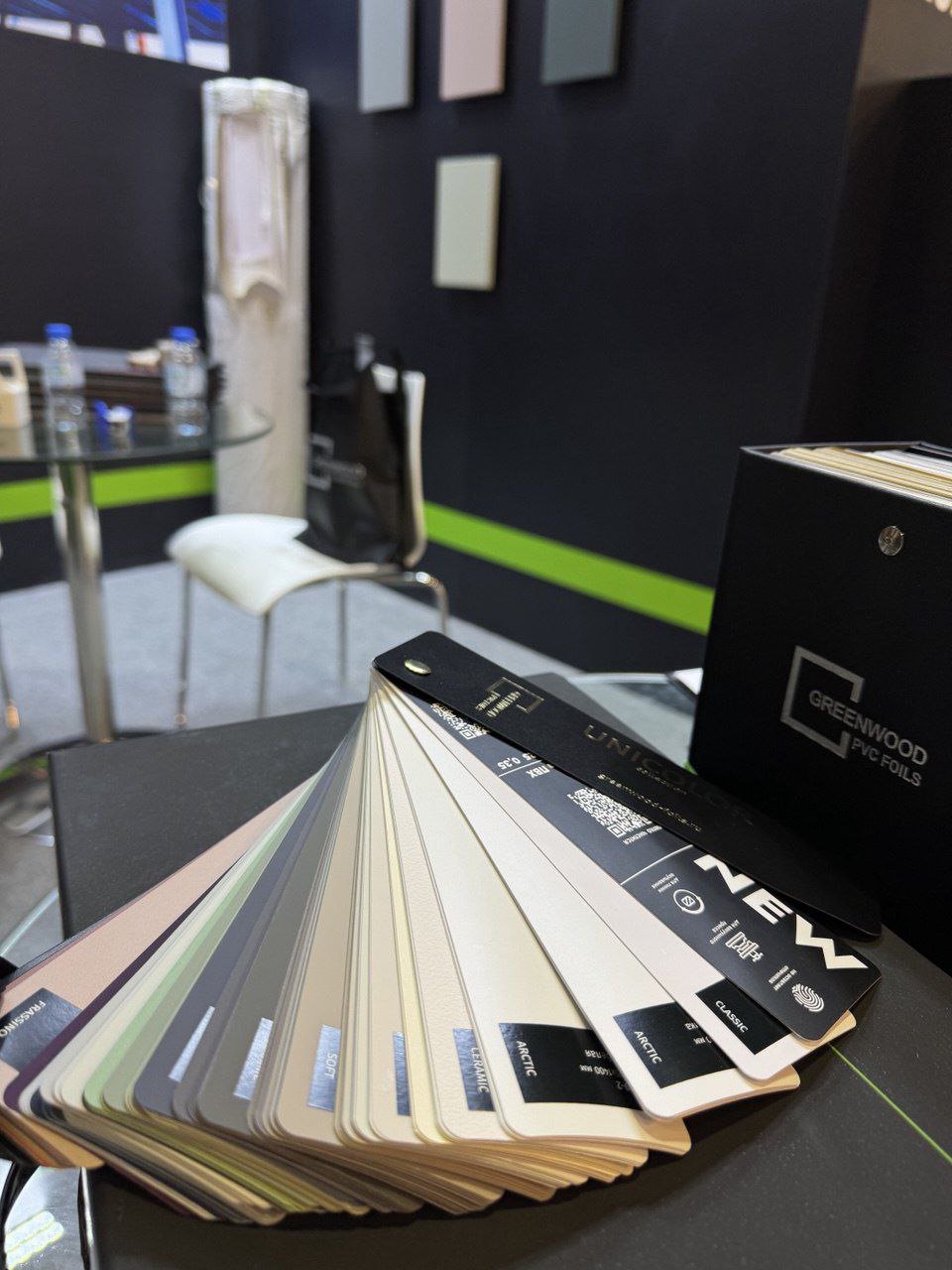 GREENWOOD PVC foils physical sample fan and branded binder in a showroom