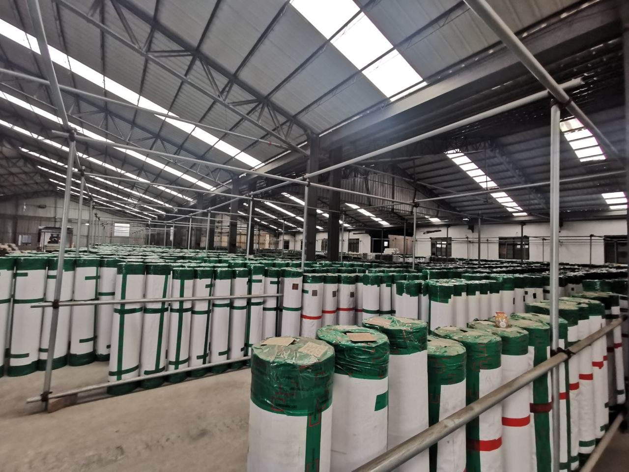 Rows of wrapped PVC film rolls stored in a GREENWOOD warehouse